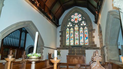 A picture showing one of the stained glass windows inside the church