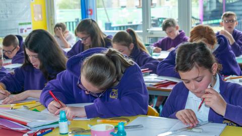 Pupils concentrating on their work in a classroom setting