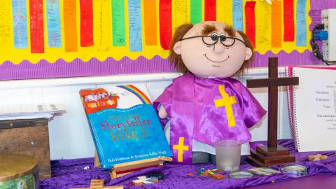 Tabletop display featuring a toy vicar holding a Bible